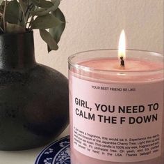 a candle that is sitting next to a vase with flowers in it and a poem written on the candle