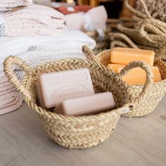 some soaps in baskets on a table