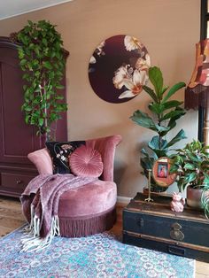 a living room filled with furniture and lots of plants