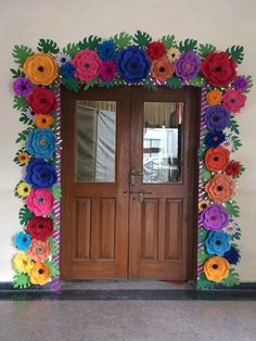 an entrance decorated with paper flowers and leaves