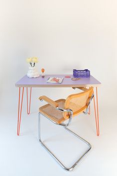 a desk with a chair and flowers on it