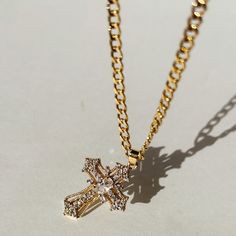 Our Miraculous Cross Necklace is the perfect symbol of faith and elegance. The cross pendant hangs on a stylish 14K Gold Filled curb chain. The Miraculous Cross Necklace is perfect for that statement piece you are looking to add to your collection.  Product Details 16" 3.5mm 14k Gold-Filled Curb Chain with 2" Extender Gold Cross Necklace With Diamond, Gold Cross Necklace Aesthetic, Golden Cross Necklace, Xoxo Jewelry, Diamond Cross Necklace Gold, Pandora Necklace, Diamond Cross Necklaces, Luxe Jewelry, Jewelry Accessories Ideas