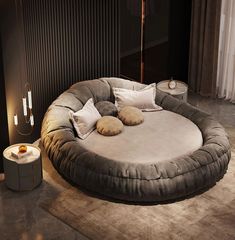 a large round bed with pillows on top of it