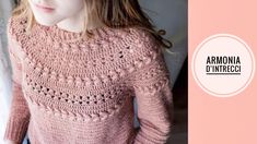 a woman is wearing a pink sweater with crocheted details on the shoulders and neck