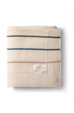 a white towel with stripes on the front and back, folded in two different colors