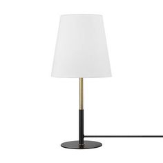 a lamp that is on top of a black stand with a white shade over it