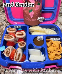 the lunch box is filled with fruit and crackers, milk, and other snacks