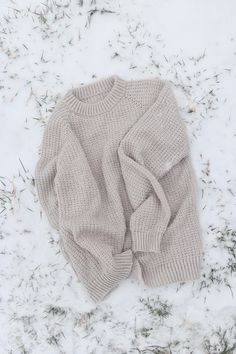 a sweater laying on top of snow covered ground