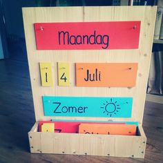 a wooden sign with several different words on it that say mandag, july, and zomer