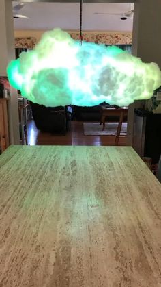 a large cloud is floating in the air over a dining room table