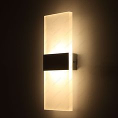 an illuminated wall light in a dark room
