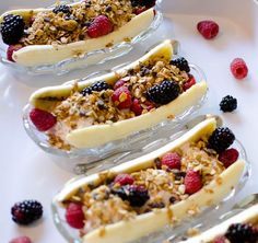 breakfast banana split with berries and granola on top