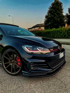 a black car parked on the side of a road