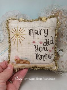 a hand is holding a pillow that says merry did you know?