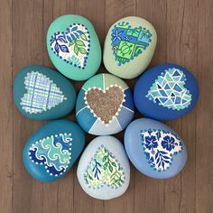 painted rocks with designs on them arranged in a circle