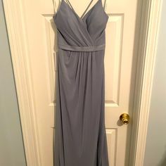 a gray dress hanging on a door