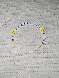 a beaded bracelet with the words bereaved spelled in black and yellow beads