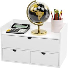 an office desk with a globe, calculator and pencils sitting on it