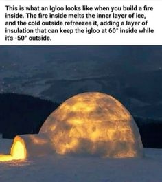 an igloo is lit up in the snow at night