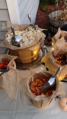 several bowls filled with food on top of a table next to pumpkins and other decorations