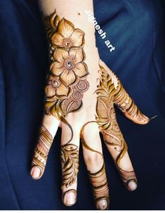 a woman's hand with hennap and flowers painted on the palm area