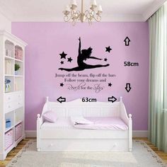 a bedroom with purple walls and stars on the wall