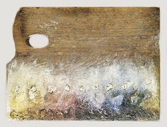 an old wooden cutting board with water drops on the wood and white paper underneath it