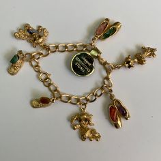 a gold charm bracelet with various charms on it