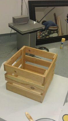 a wooden box sitting on top of a table next to a mirror and other items