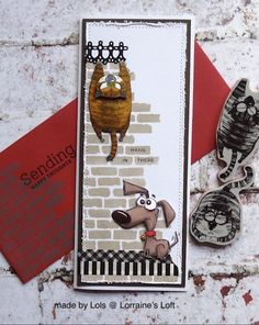 a card with a dog on it next to some scissors and paper cutters in front of a brick wall