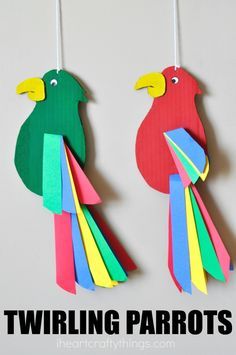 two paper parrots hanging from strings with the words twining parrots on them