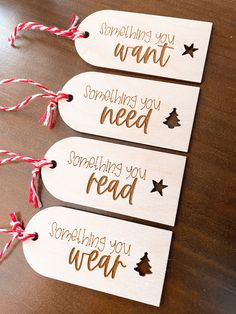 three wooden tags with words on them that say something you want, something you need, something you read and something you wear