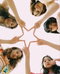 four girls making a star shape with their hands