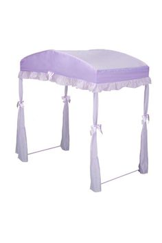 a purple and white canopy bed with ties on the sides, tied to it's sides