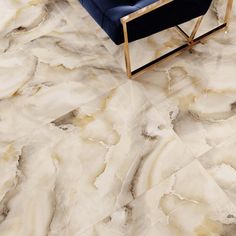 a blue chair sitting on top of a marble floor