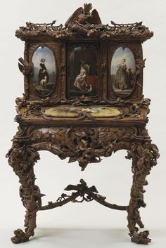 an ornate wooden table with paintings on it