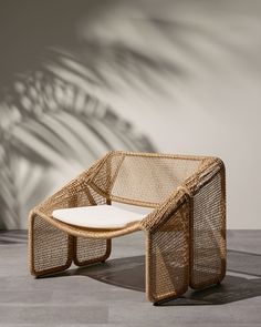 a wicker chair sitting on top of a cement floor