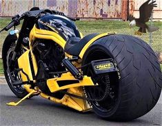 a yellow and black motorcycle parked on the street