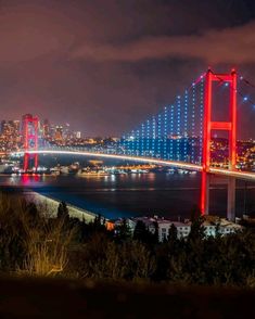 the city lights shine brightly over the bay bridge