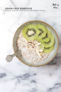 a bowl filled with oatmeal topped with kiwi slices