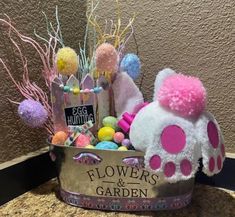 a basket filled with lots of candy and flowers