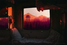 there is a bed in front of the window with mountains and trees on it at night