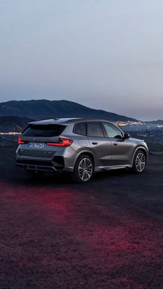 a grey car parked on top of a dirt field