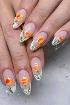 Long almond-shaped spring nails feature white French tips and orange flowers with green leaves French Tips, White French Tips, Soft And Feminine, White French Tip, Almond Shaped, White French