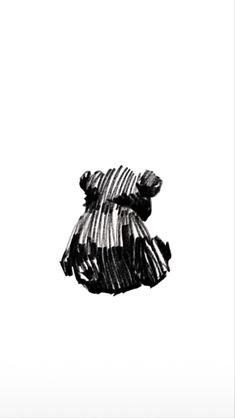 a black and white photo of a teddy bear wearing a striped dress with its mouth open