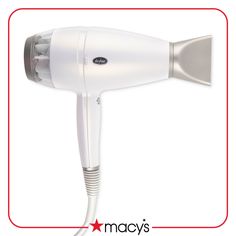 a white hair dryer sitting on top of a red and white sign that says macy's