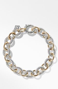 a gold and silver bracelet with two tone links on the clasp, one is made out of