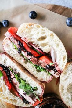 a close up of a sandwich with blueberries and strawberries