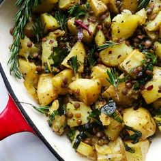 a skillet filled with potatoes and herbs
