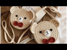 two crocheted bags with faces on them and one has a red bow tie